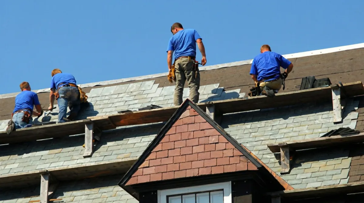 Roof replacement in progress with a team of professional contractors installing new shingles on a residential home in Reno, NV